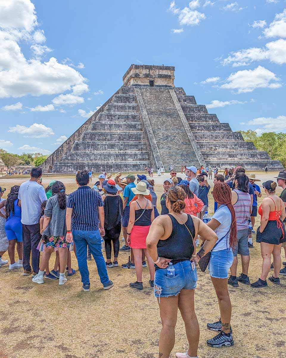 A tour group in front of El Castillo at Chichen Itza, Mexico