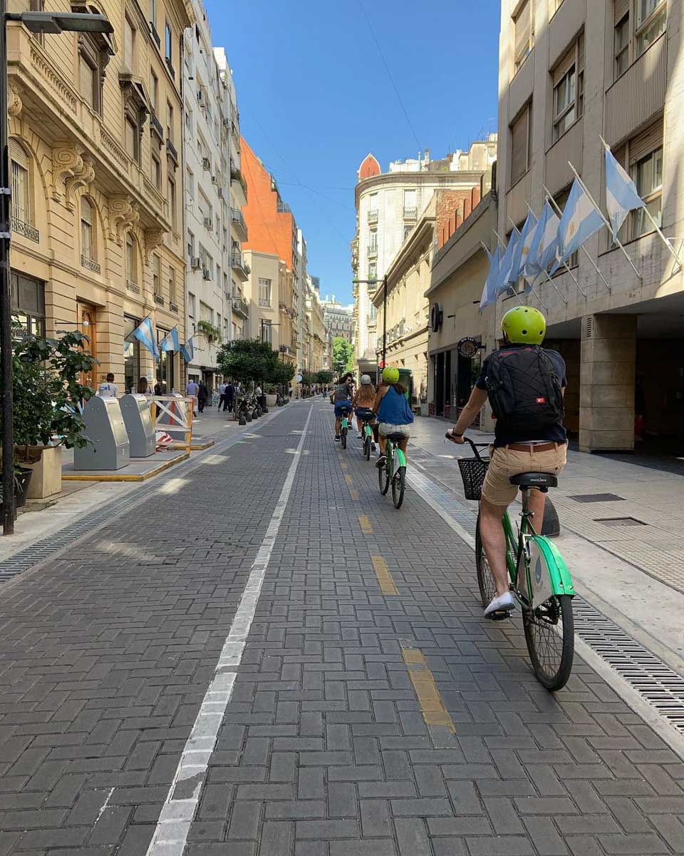 A group of people bike around Buenos Aires on a BA Bikes Tour