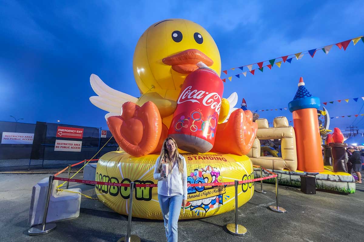 Bailey poses with a blow up duck at the Richmond Night Market