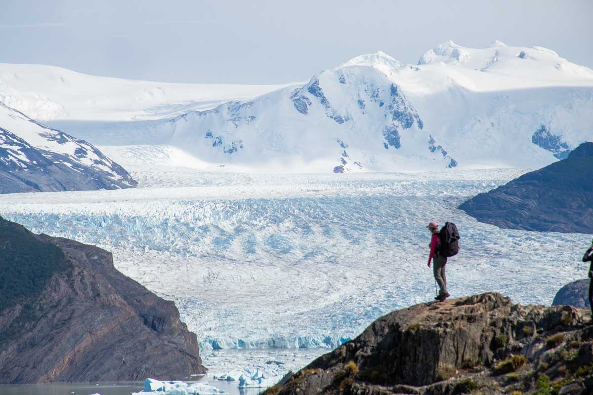 Bailey stands on a rock overlooking Glacier Grey