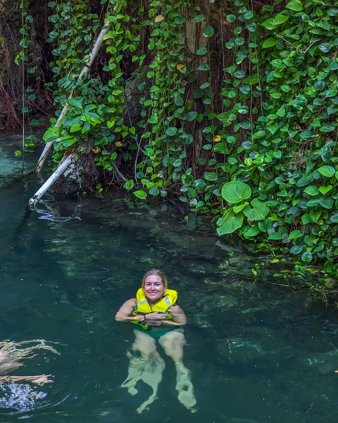 Bailey swims in a cenote in Valladolid, Mexico