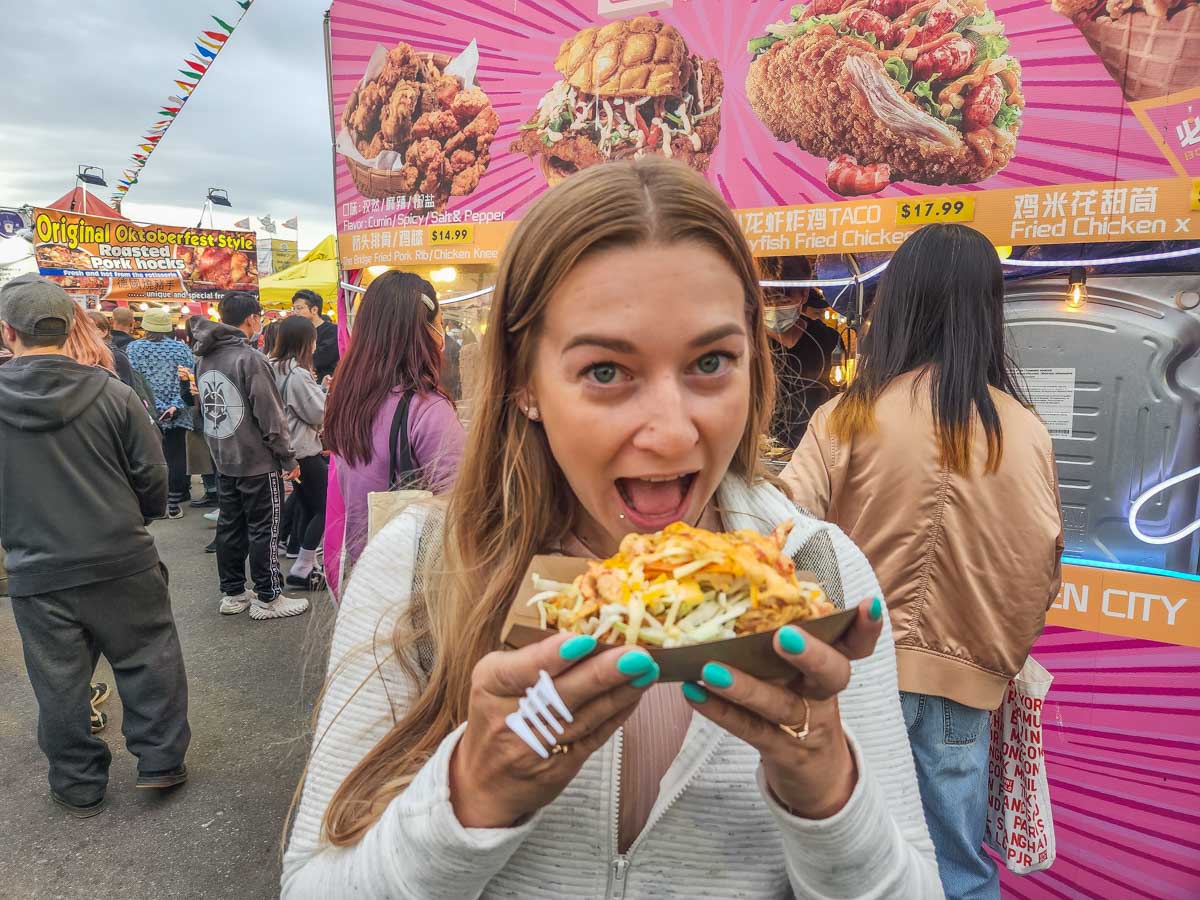 Bailey takes a bite from her fried chicken Taco, Richmond Night Market