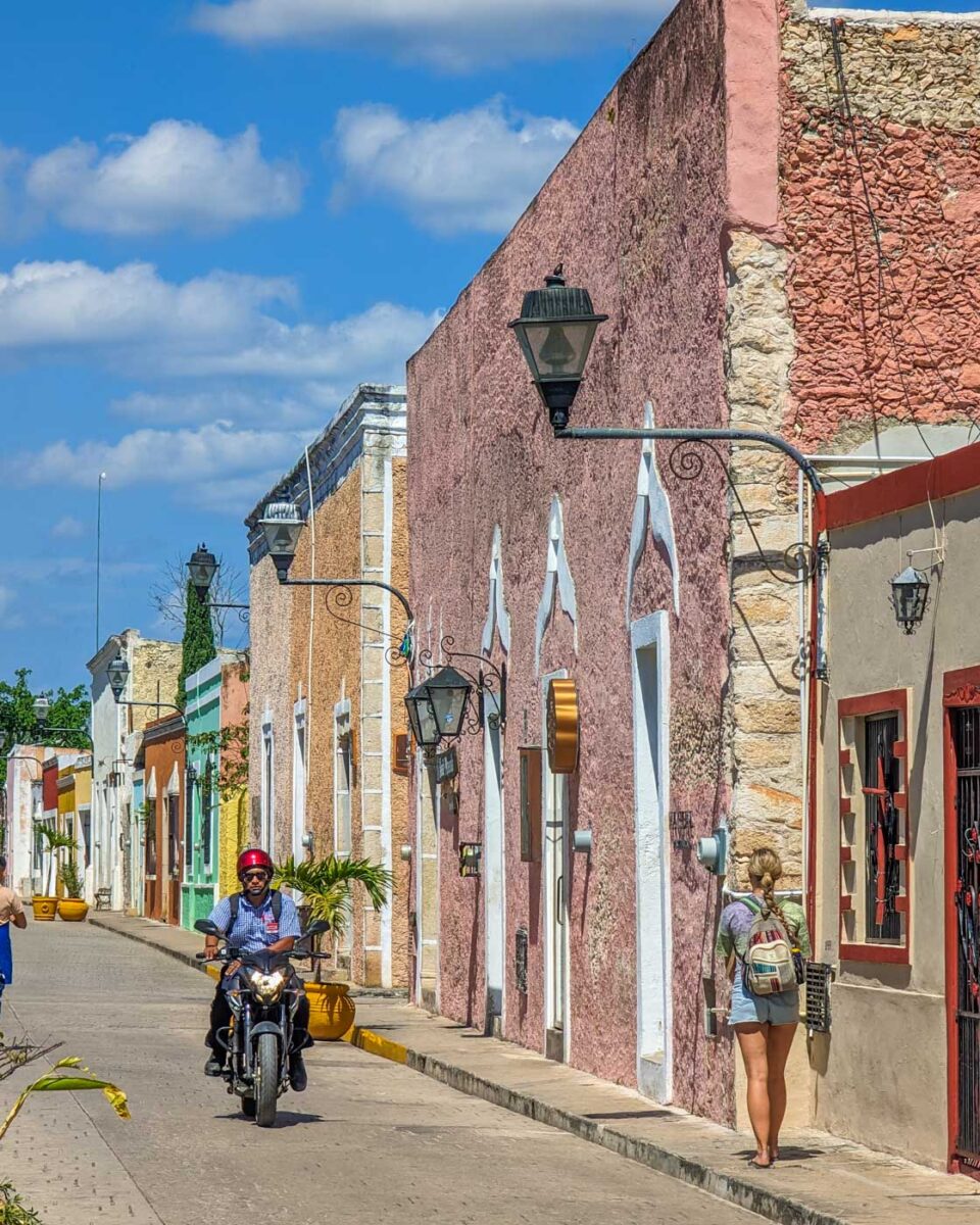 Bailey walks down the cute street of Calzada de los Frailes in Valladolid, Mexico