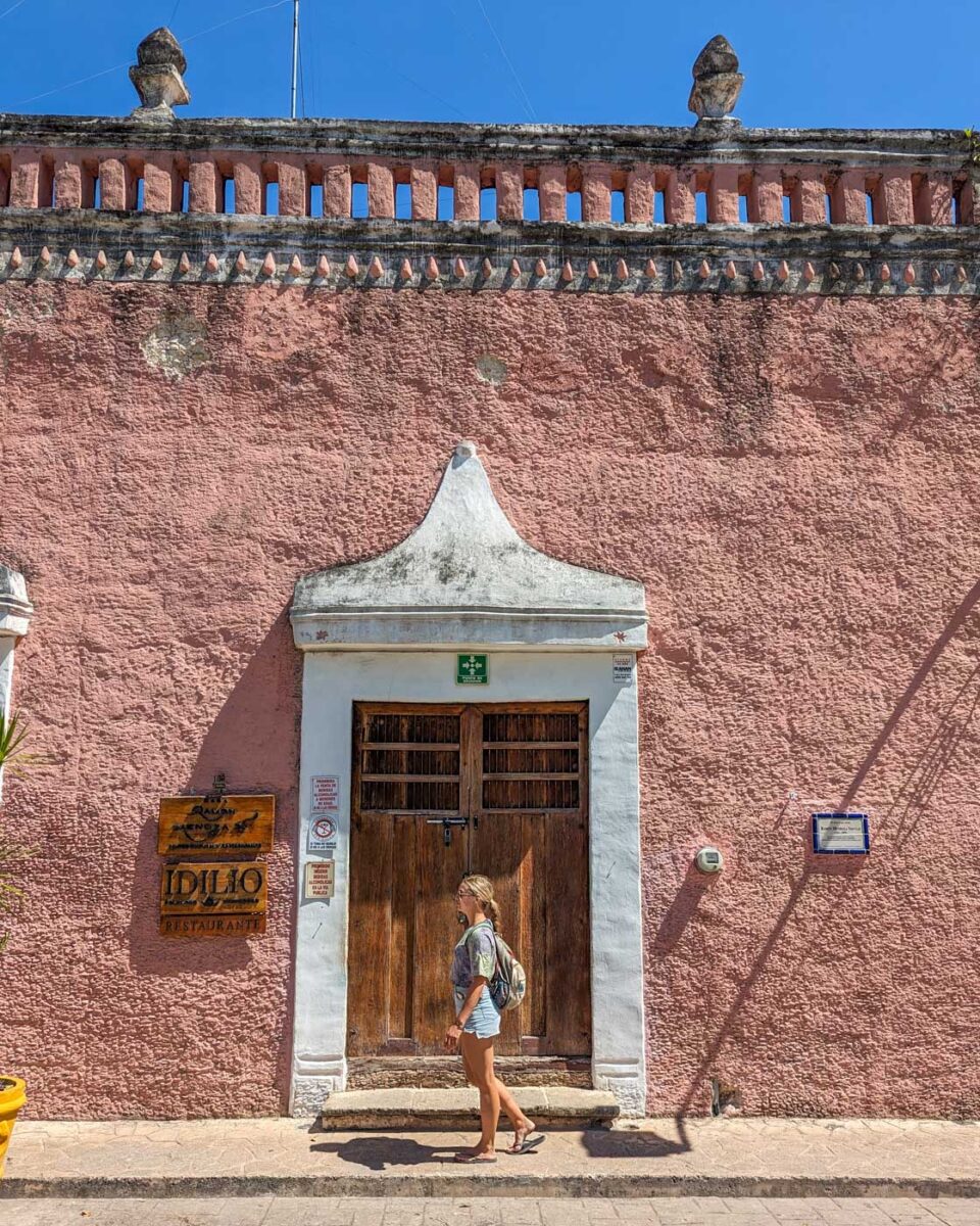 Bailey walks past a cute building along Calzada de los Frailes in Valladolid, Mexico