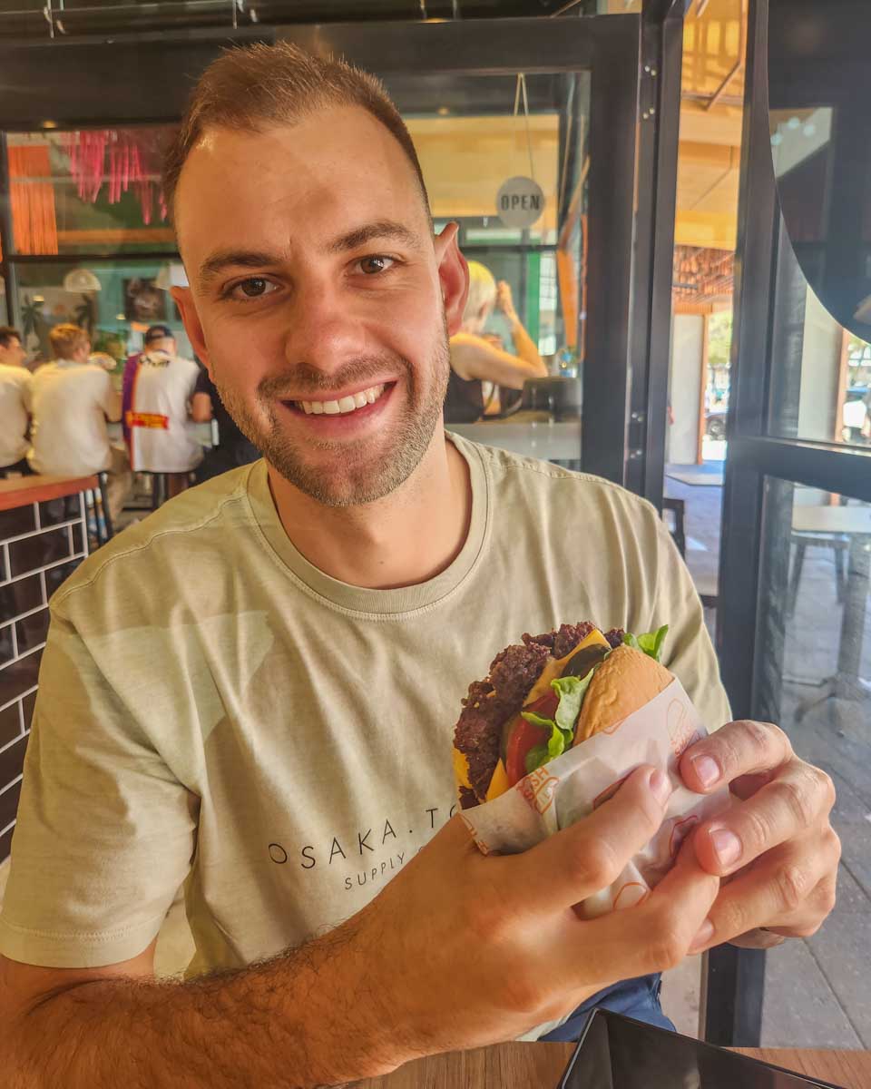 Daniel enjoys a burger at Smash Grill in Fremantle