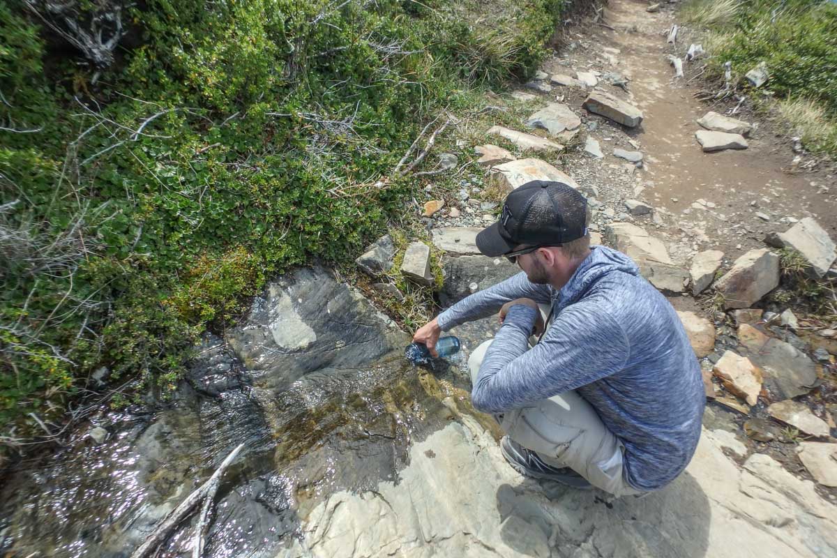 Filling a water bottle right from the stream! 