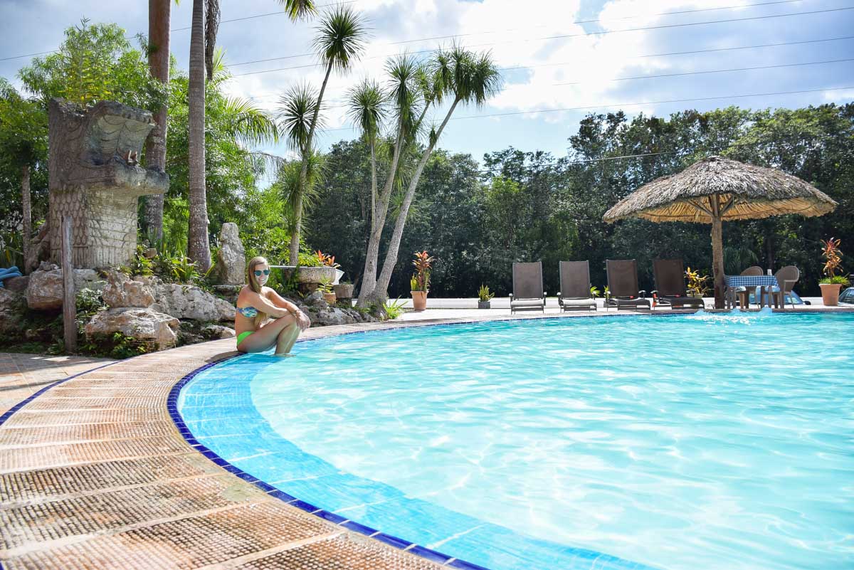 A lady relaxes at the pool at Hotel Doralba Inn Chichen Itza, Mexico