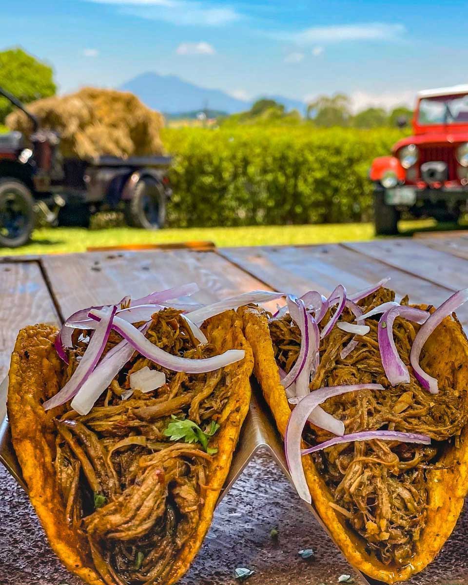 Two hard shell tacos at La Tasca Antigua with a beautiful view in Antigua, Guatemala