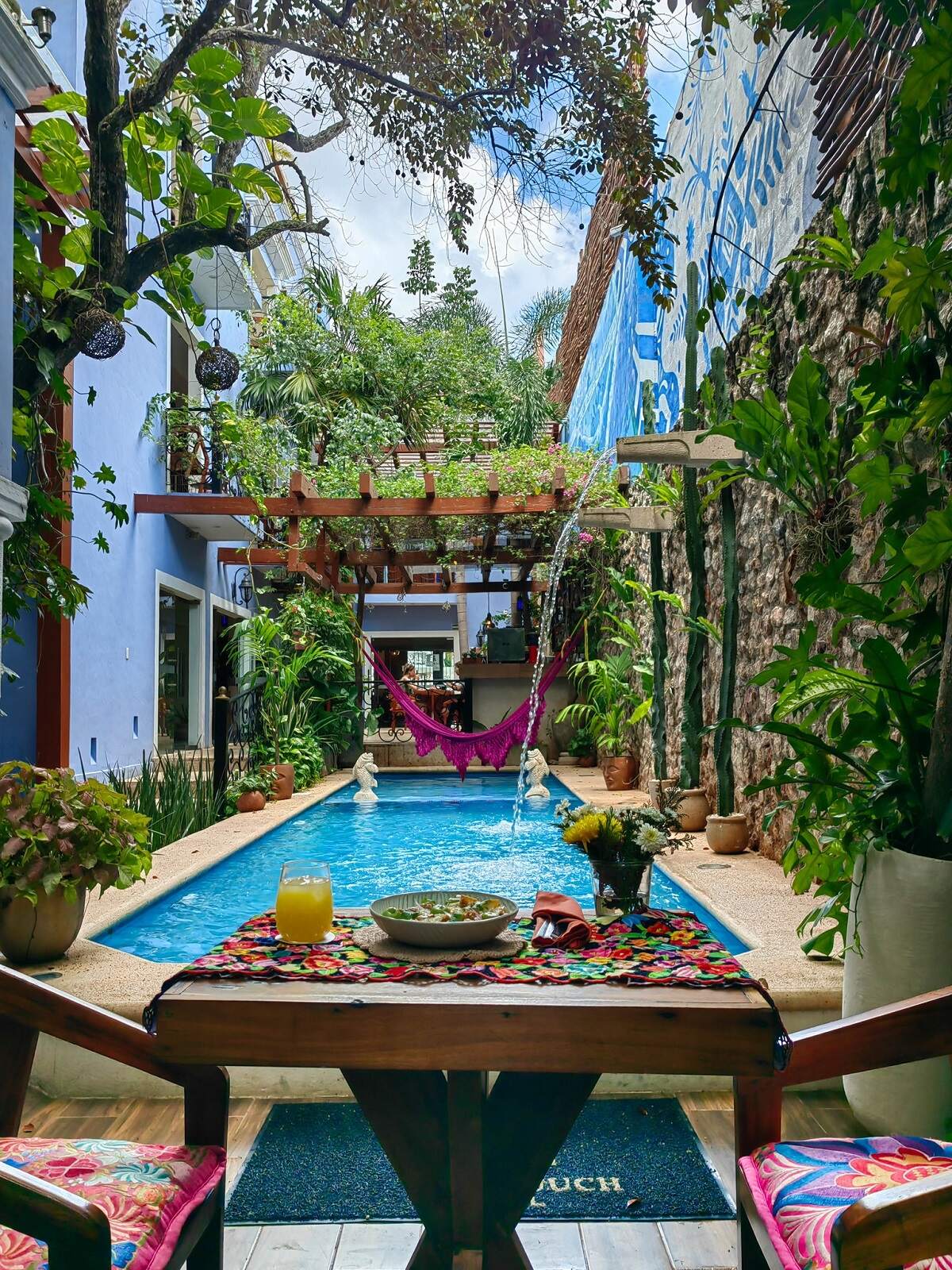 the outdoor pool and courtyard at Le Muuch Hotel