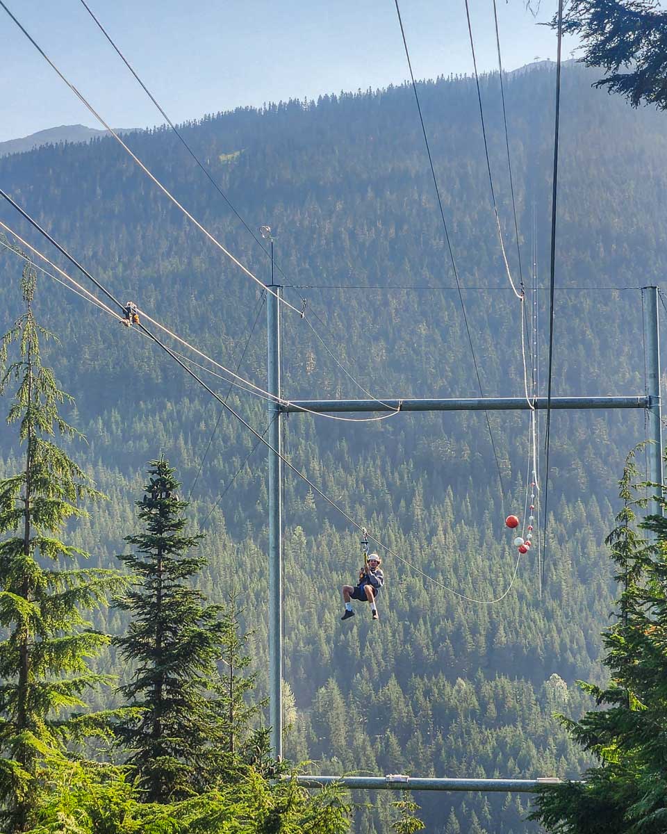 A person zooms towards the end of the Sasquatch zip line in Whistler, BC