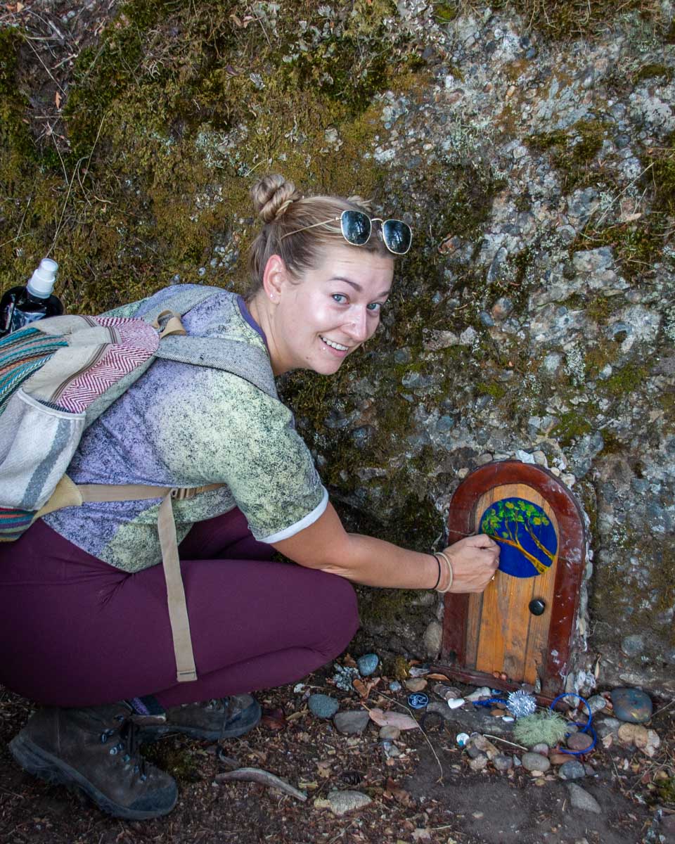 Bailey at one of the gnome doors on the trail to the top of Mount Erskine on Salt Spring Island