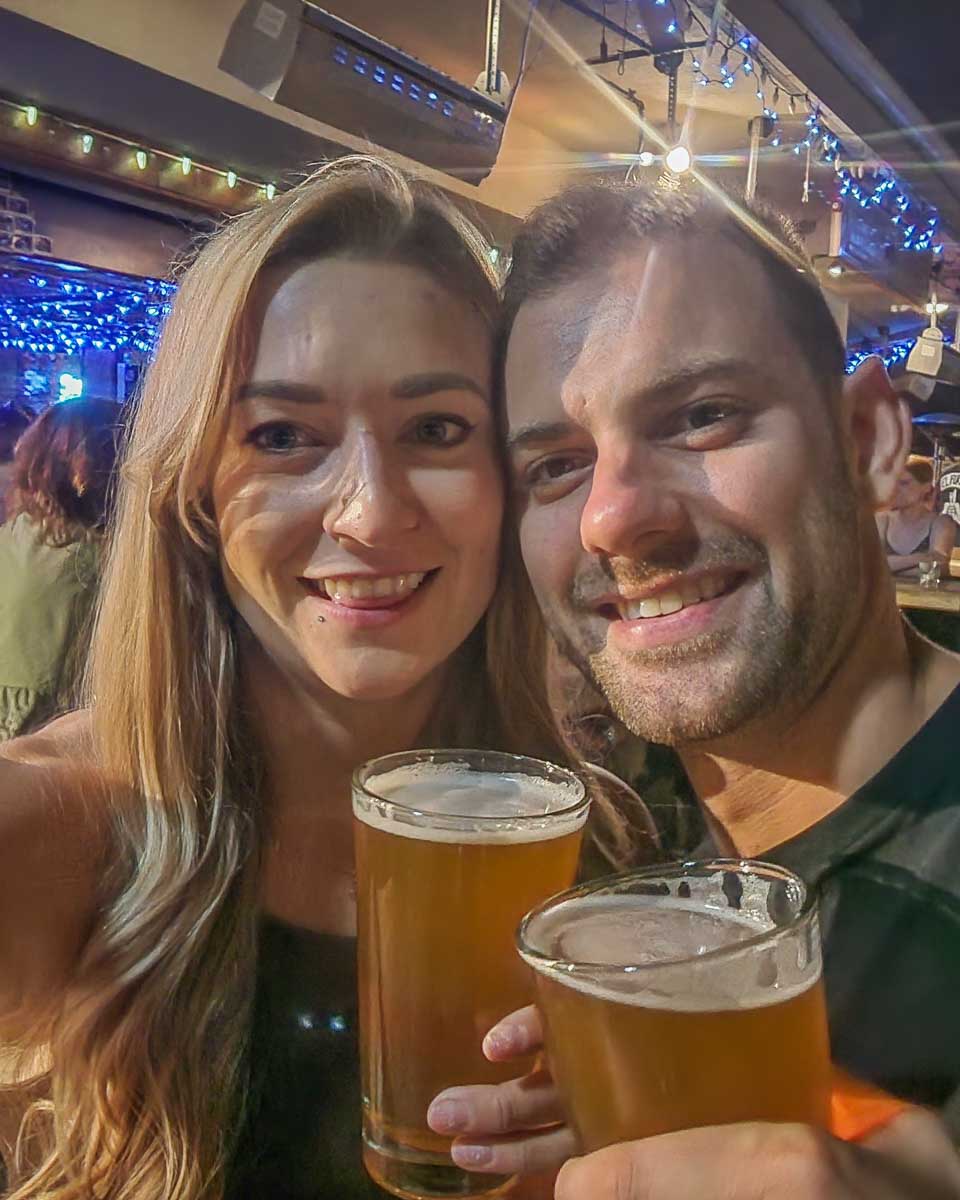 Bailey and Daniel at El Furniture Warehouse having beers in Whistler, BC