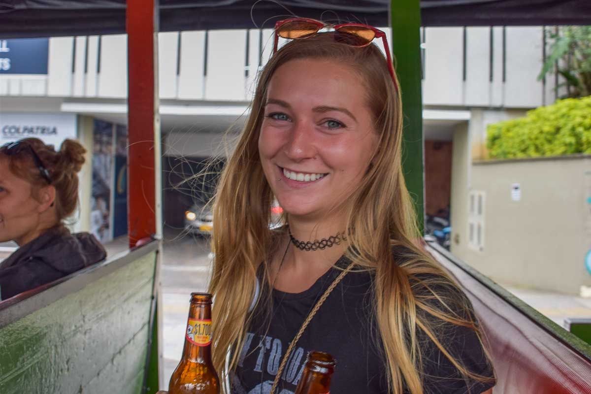 Bailey drinks a beer in Colombia