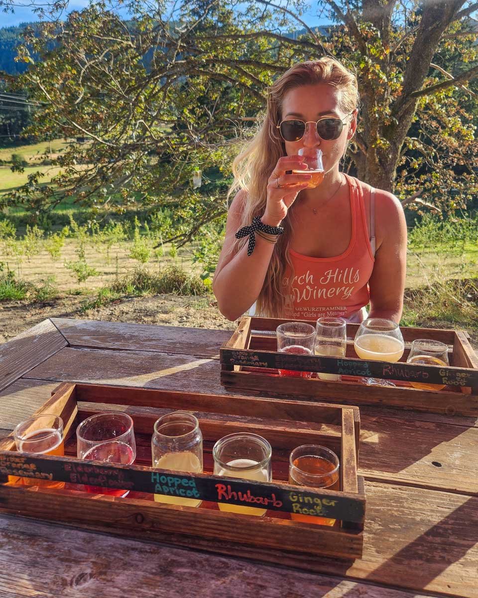 Bailey drinks cider at Salt Spring Wild Cider on their outdoor deck