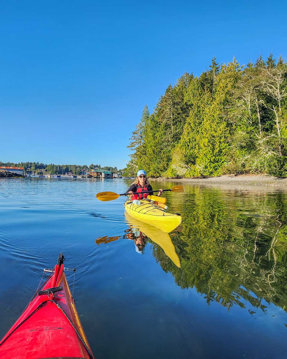 Bailey kayaks through the islands around Tofino on Vancouver Island