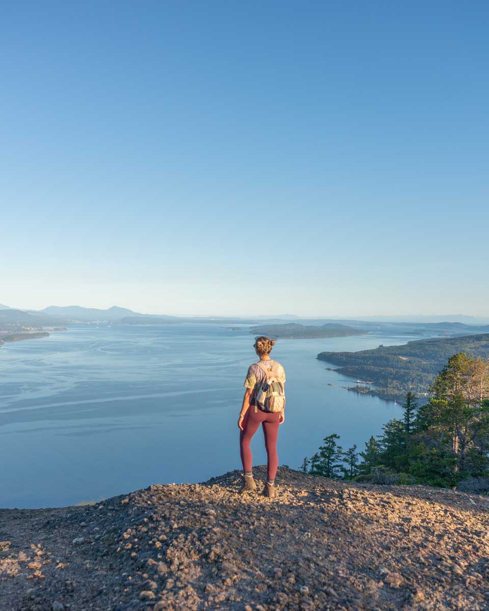Bailey stands at the top of Mount Erskine looking at the view on Salt Spring