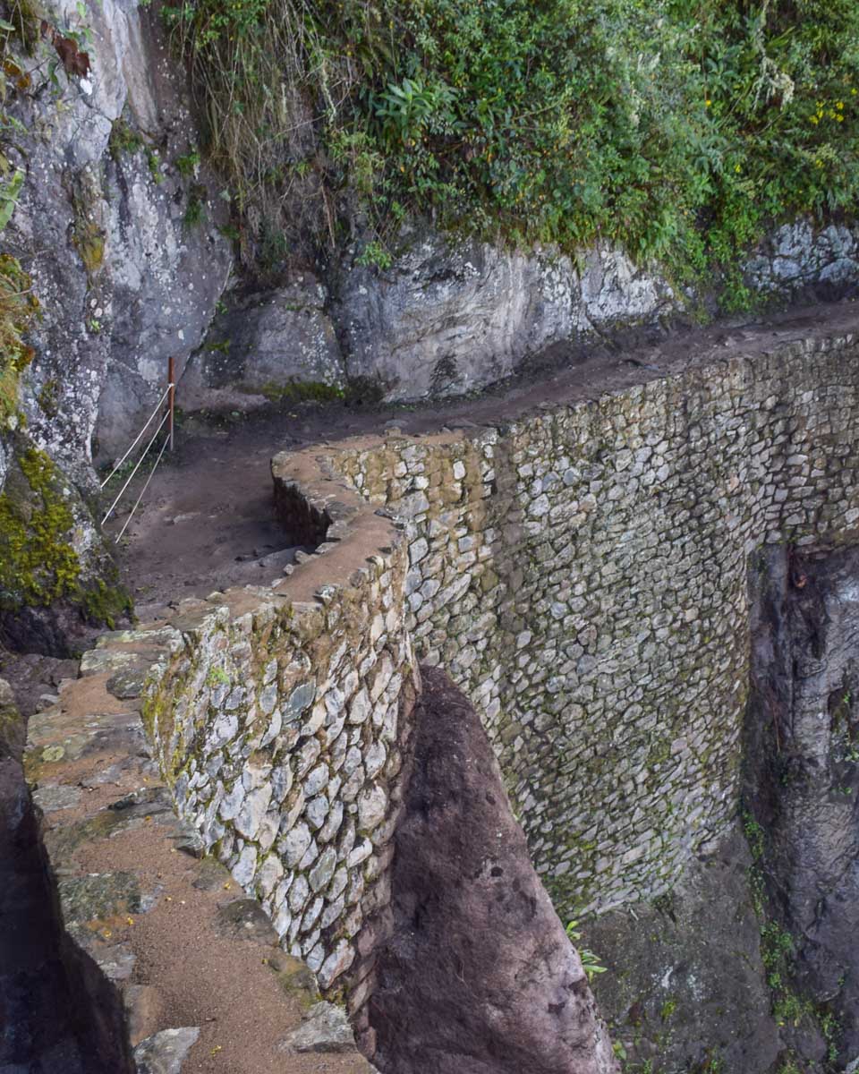 The stone pathway along the edge of the cliff that leads to the Inca Bridge at Machu Picchu