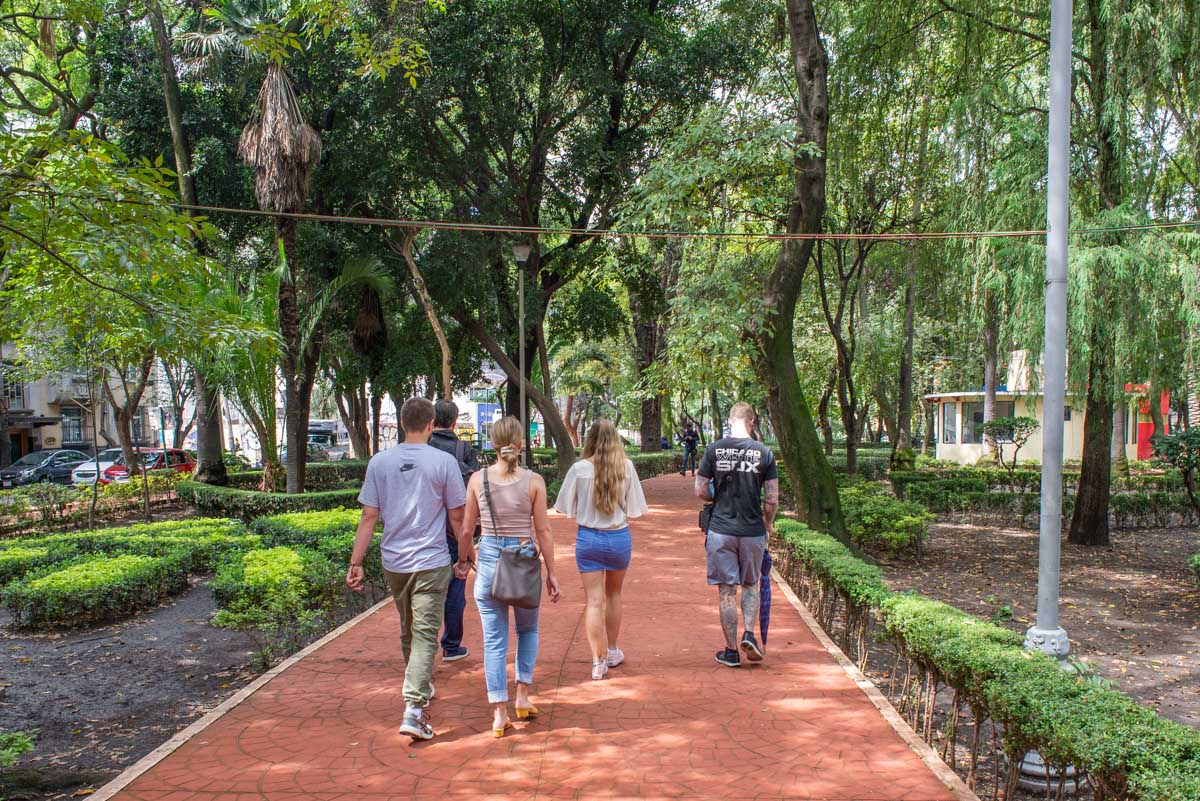 A group of people walk around Mexico City