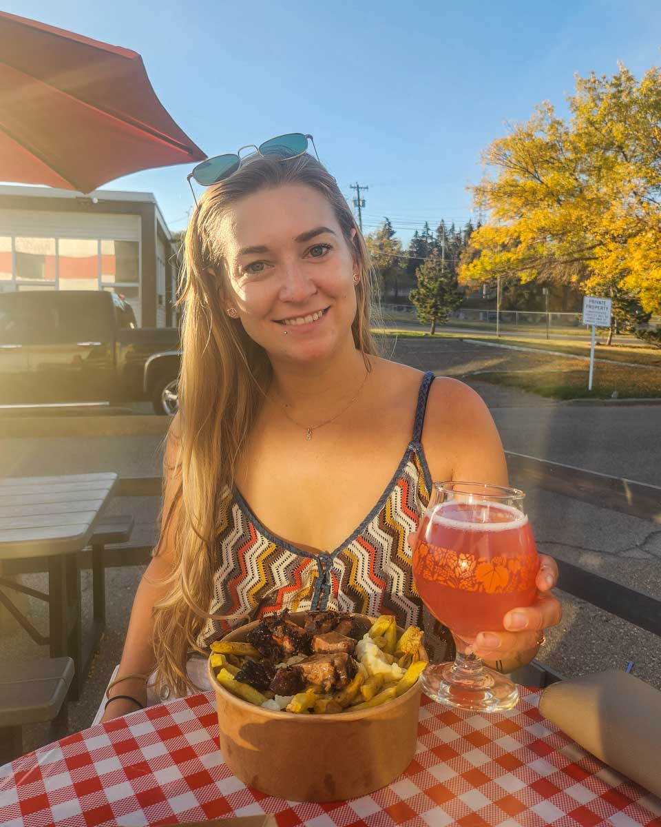 girl enjoys a craft beer at Paddys Barbecue Brewery's outdoor patio in autumn