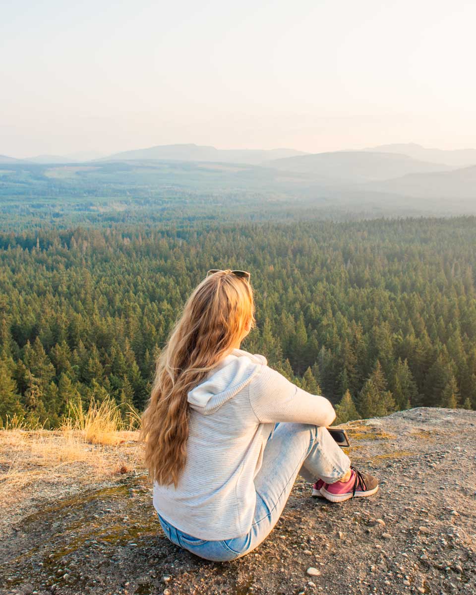 Bailey sits and enjoys the view from Little Mountain Lookout for Sunset in Parksville