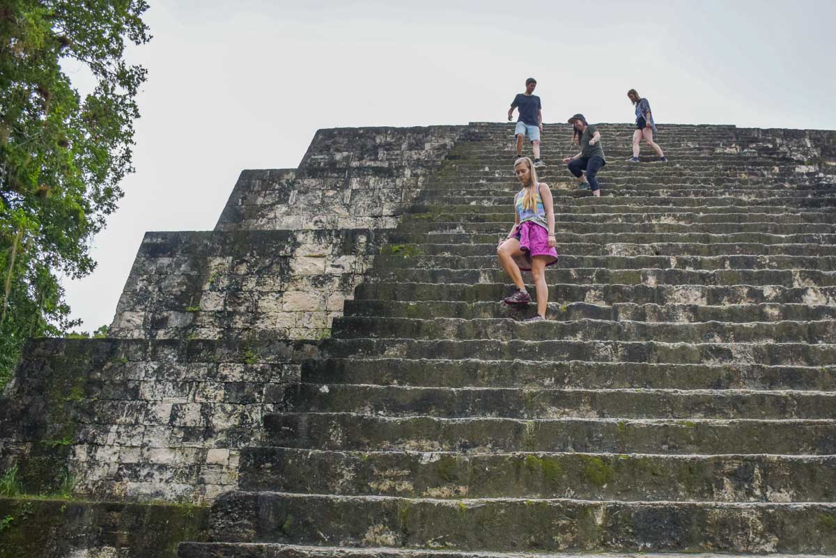 Bailey walks up some steps at a temple in Tikal