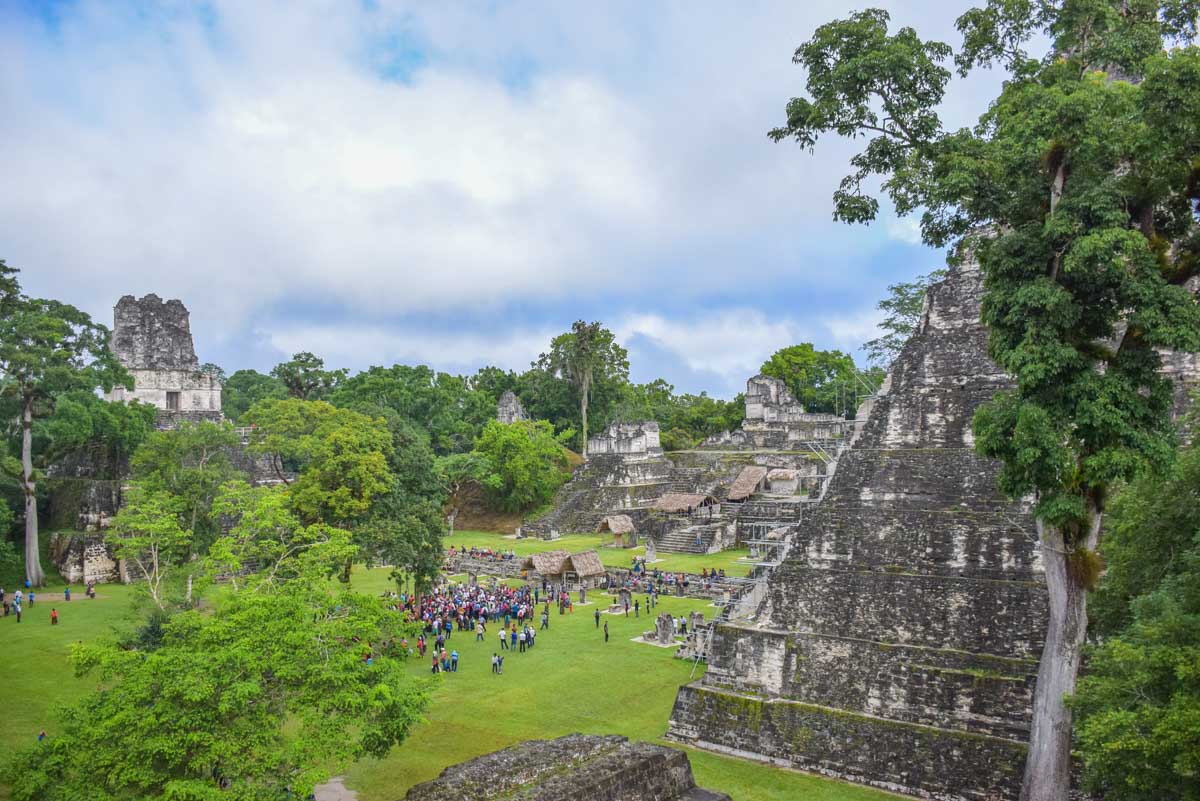 Group of people gather in the center of Tikal, Guatemala