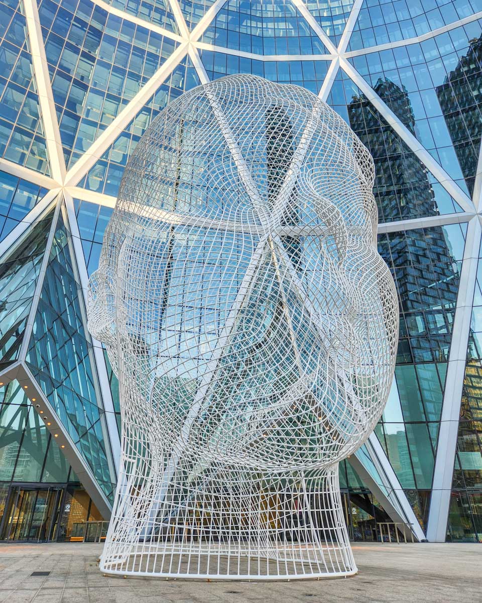 Wonderland Statue in front of the Bow Building