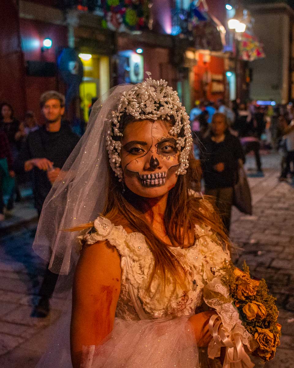 A local Mexican lady dressed in a scary wedding dress during Day of the Dead in Mexico