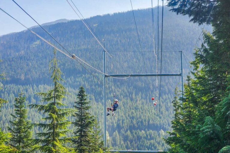 A person comes down the Sasquatch zipline in Whistler as seen from the bottom