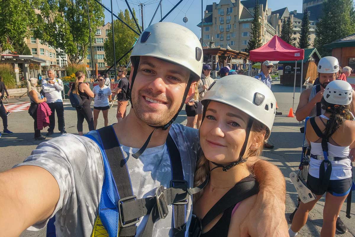 Daniel and Bailey take a selfie with their zipline gear and helmets in Whistler