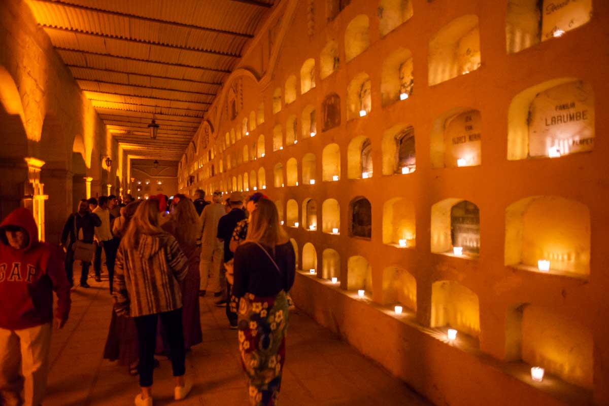 People walk through a graveyard in Oaxaca during Day of the Dead