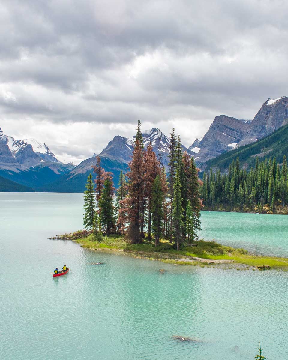 A person canoes around Spirit Island on Maligne Lake, Canada