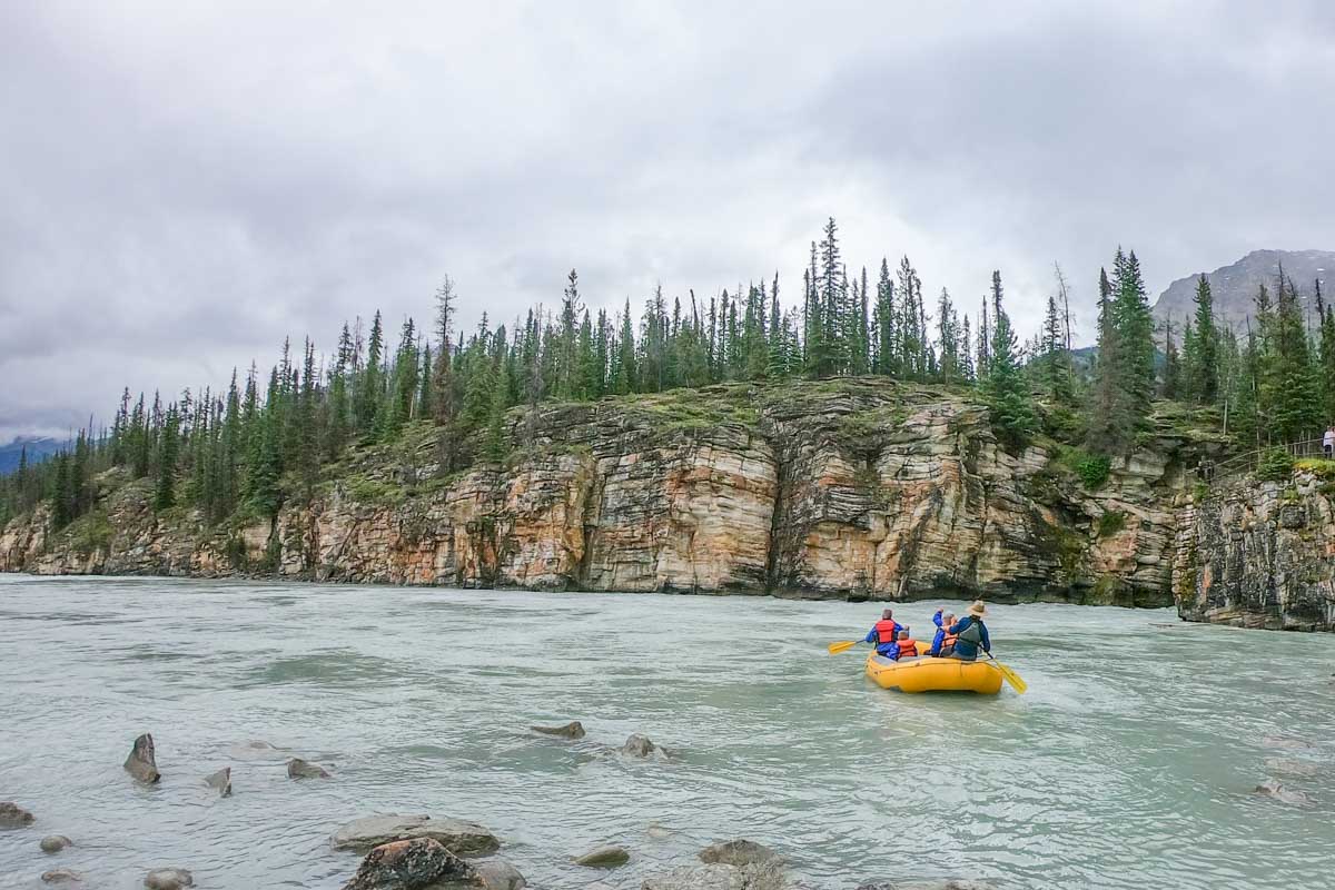 A raft floats down the Athabasca river in Jasper on a white water rafting tour