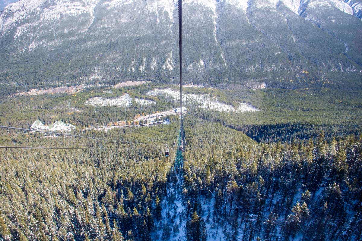 A view down the cable of the Banff Gondola from the top showing the cable cars