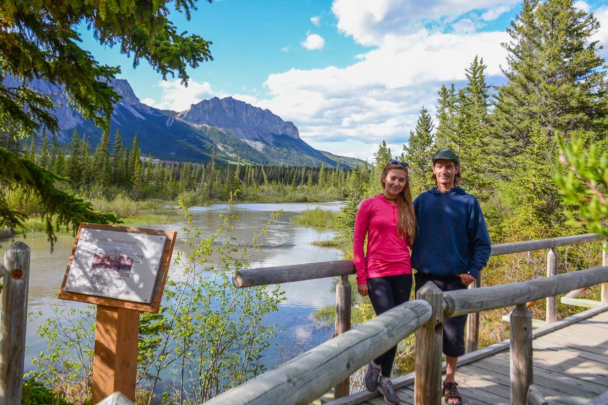 Bailey and her dad pose for photo with views of Mount Yamnuska in Bow Valley Provincial Park