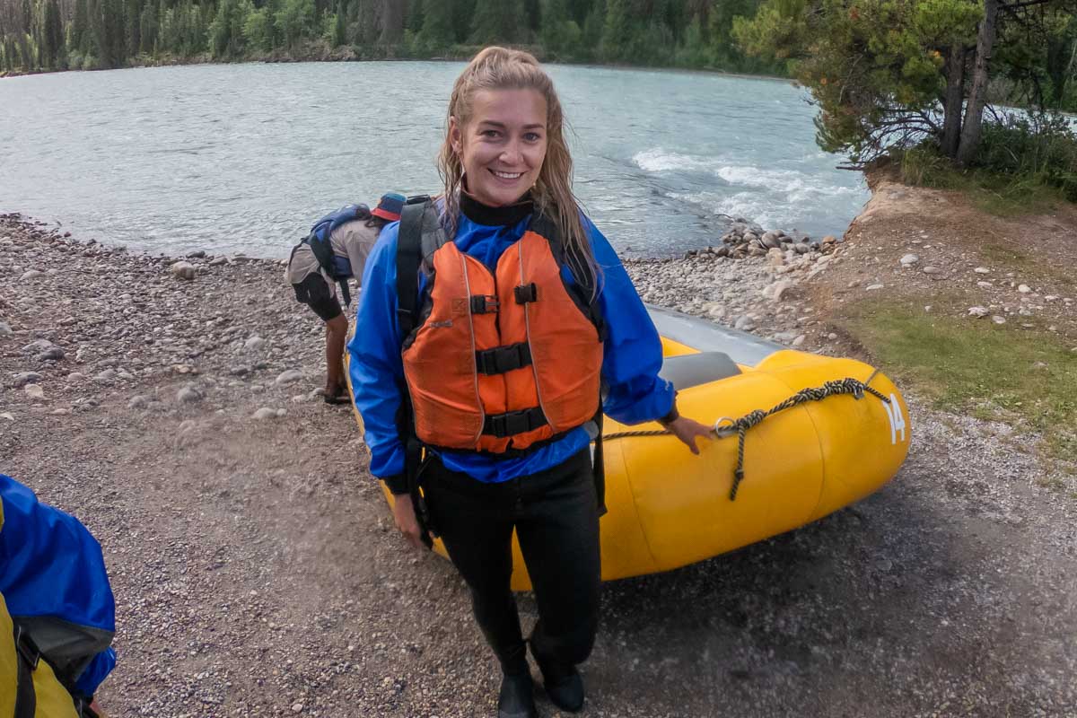 Bailey on a white water rafting tour in Jasper posses for a photo after rafting on the river