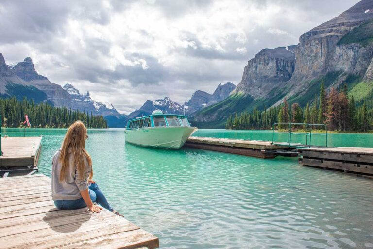 Bailey sits on the dock looking out over Maligne Lake on the tour to Spirit Island, Jasper National Park