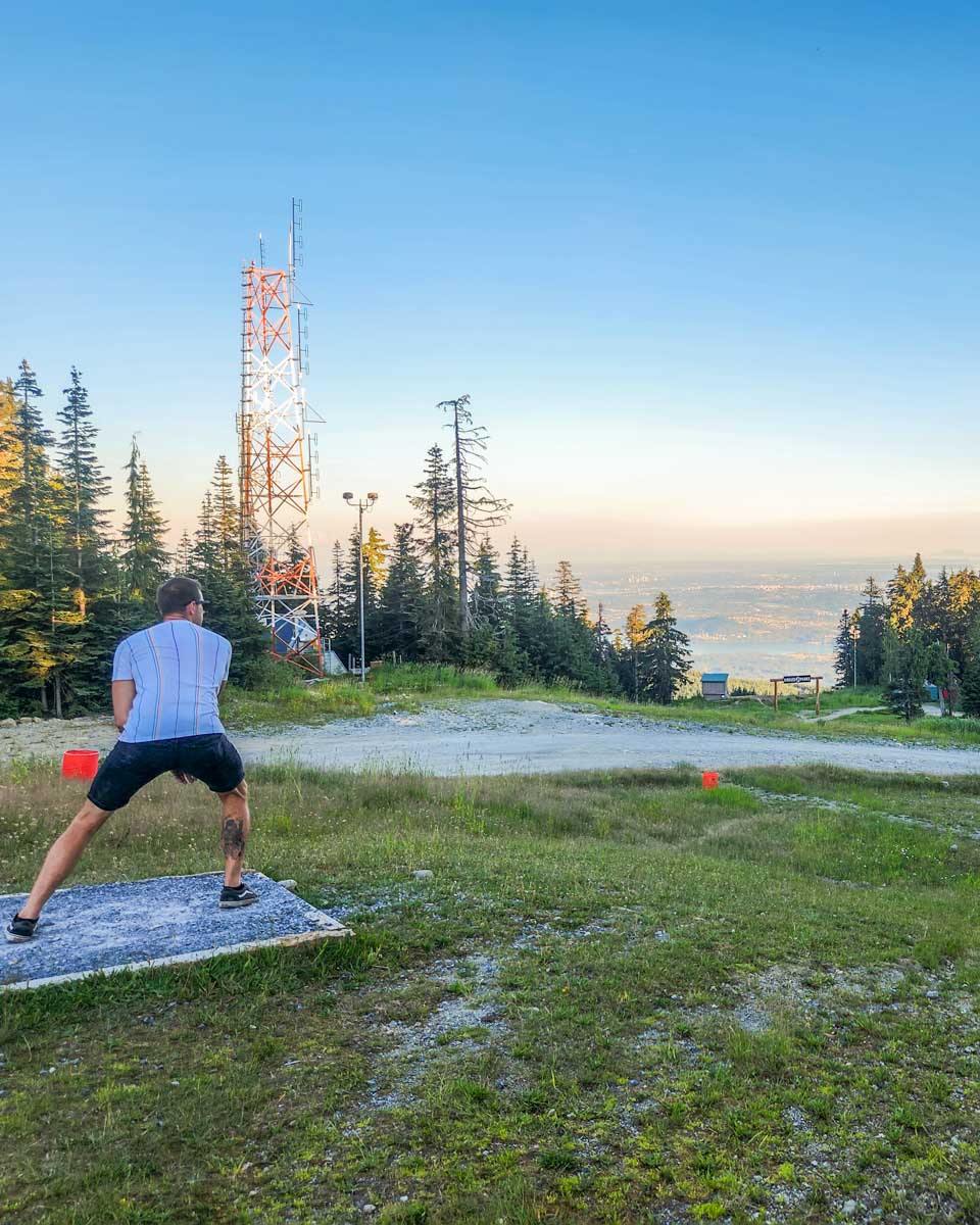 Daniel plays disc golf on Grouse Mountain, Vancouver at sunset