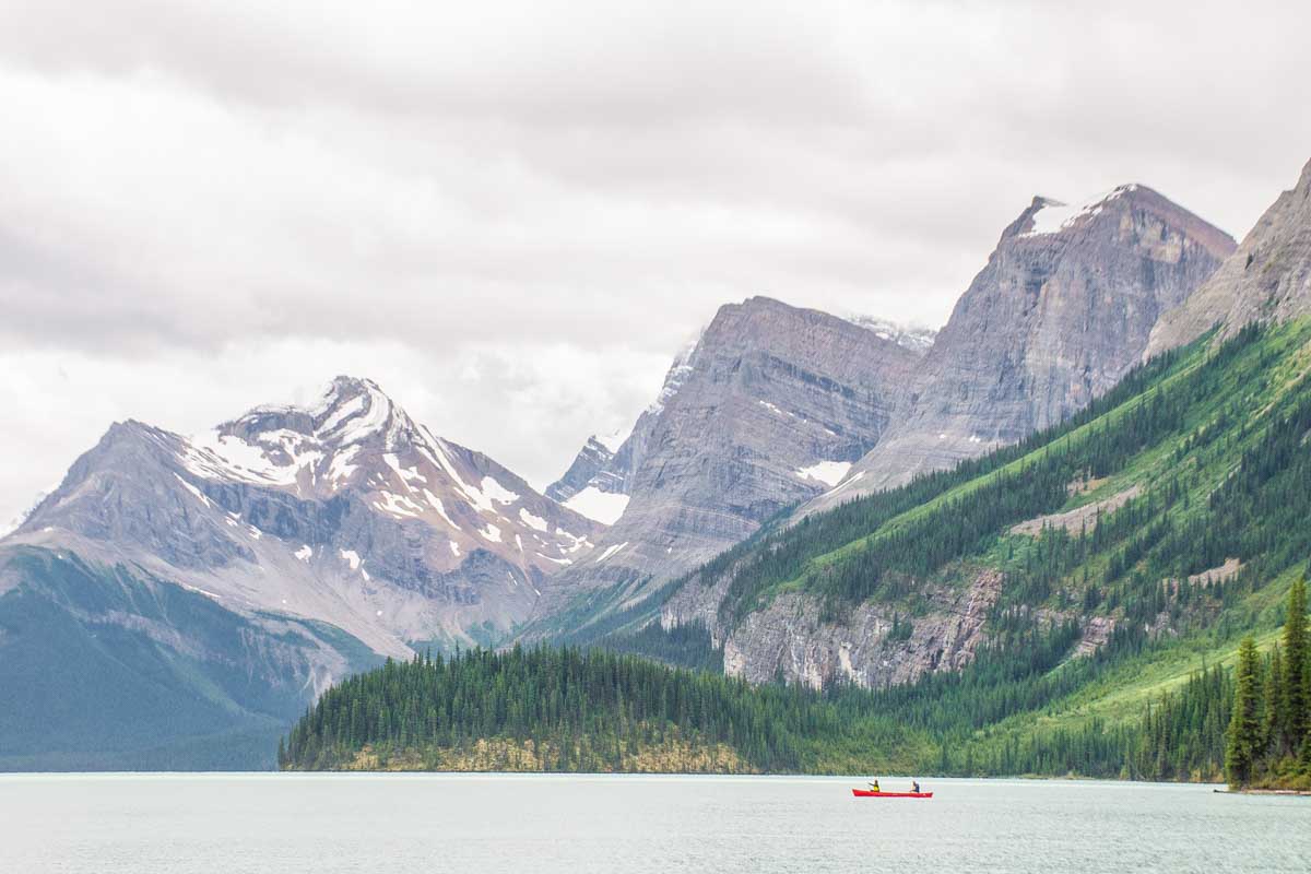 Two people canoe on Maligne Lake on their way to Spirit Island