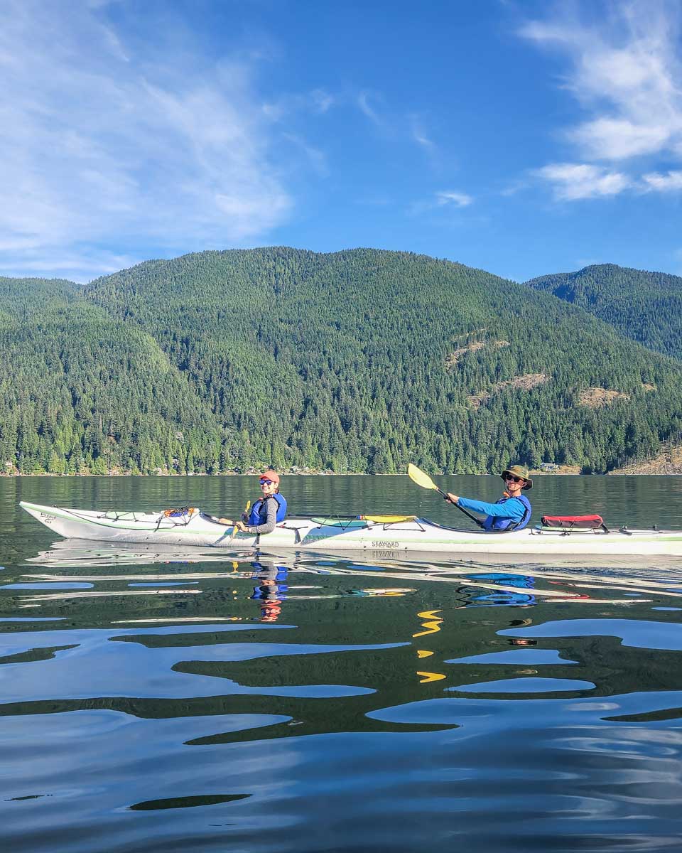 Two people kayak in Deep Cove, Vancouver