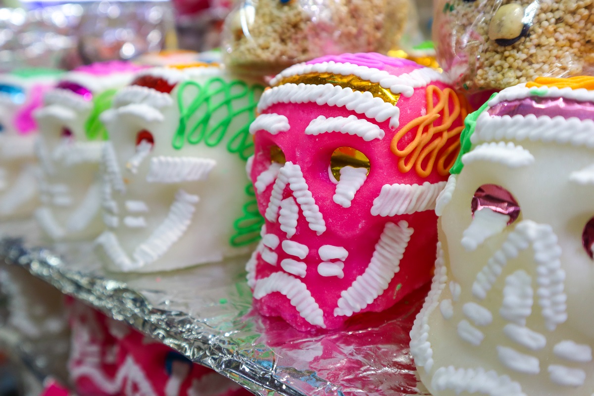 a collection of colorful sugar skulls for sale in Mexico