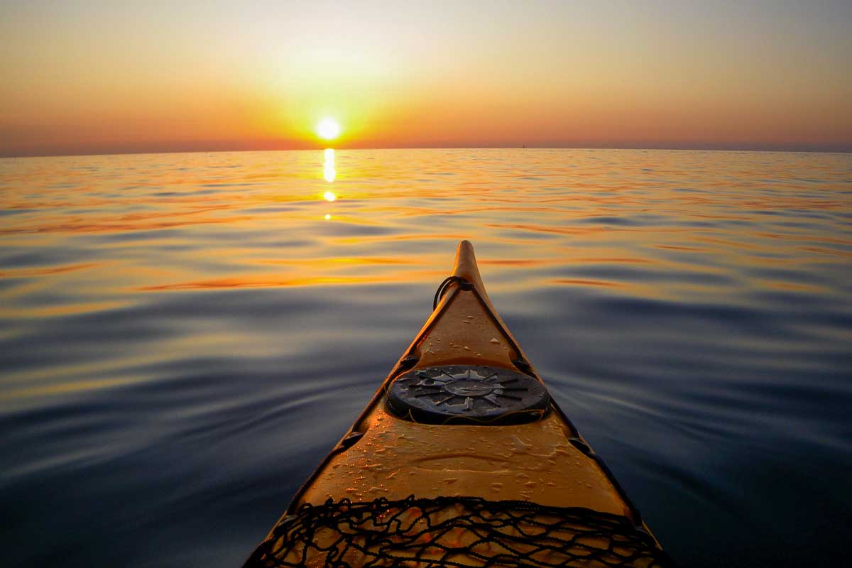 A person kayaks at sunset from Cartagena Colombia