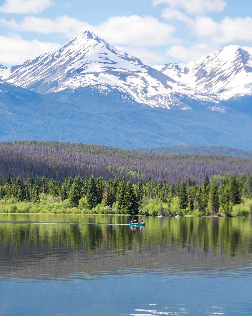 Two people conoe at the stunning Pyramid Lake in Jasper National Park, Canada