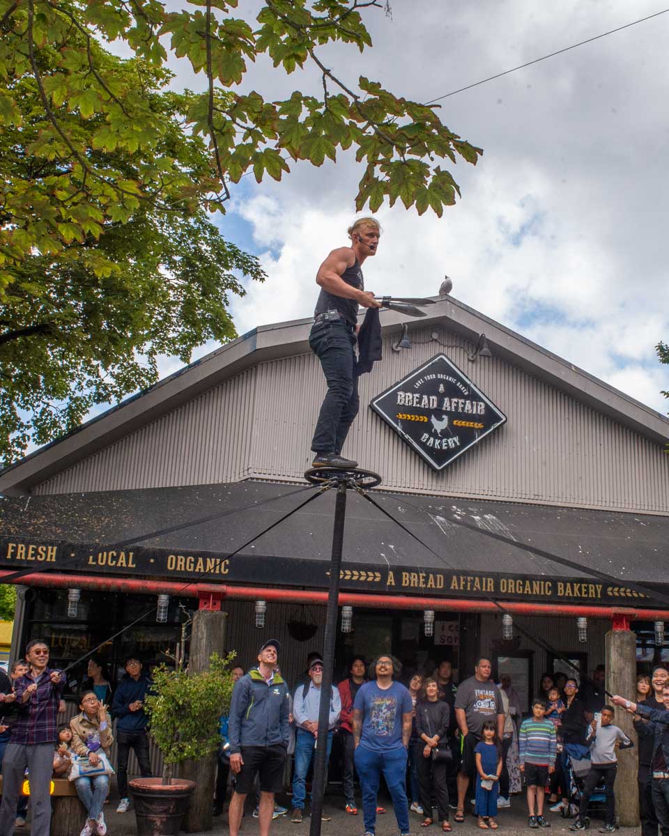 A street performer on Granville Island performs in summer