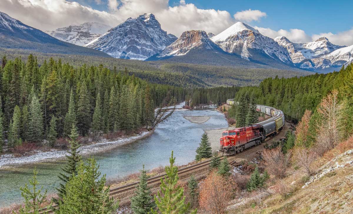 A train travels past Morant's Curve in Banff along the Bow Valley Parkway