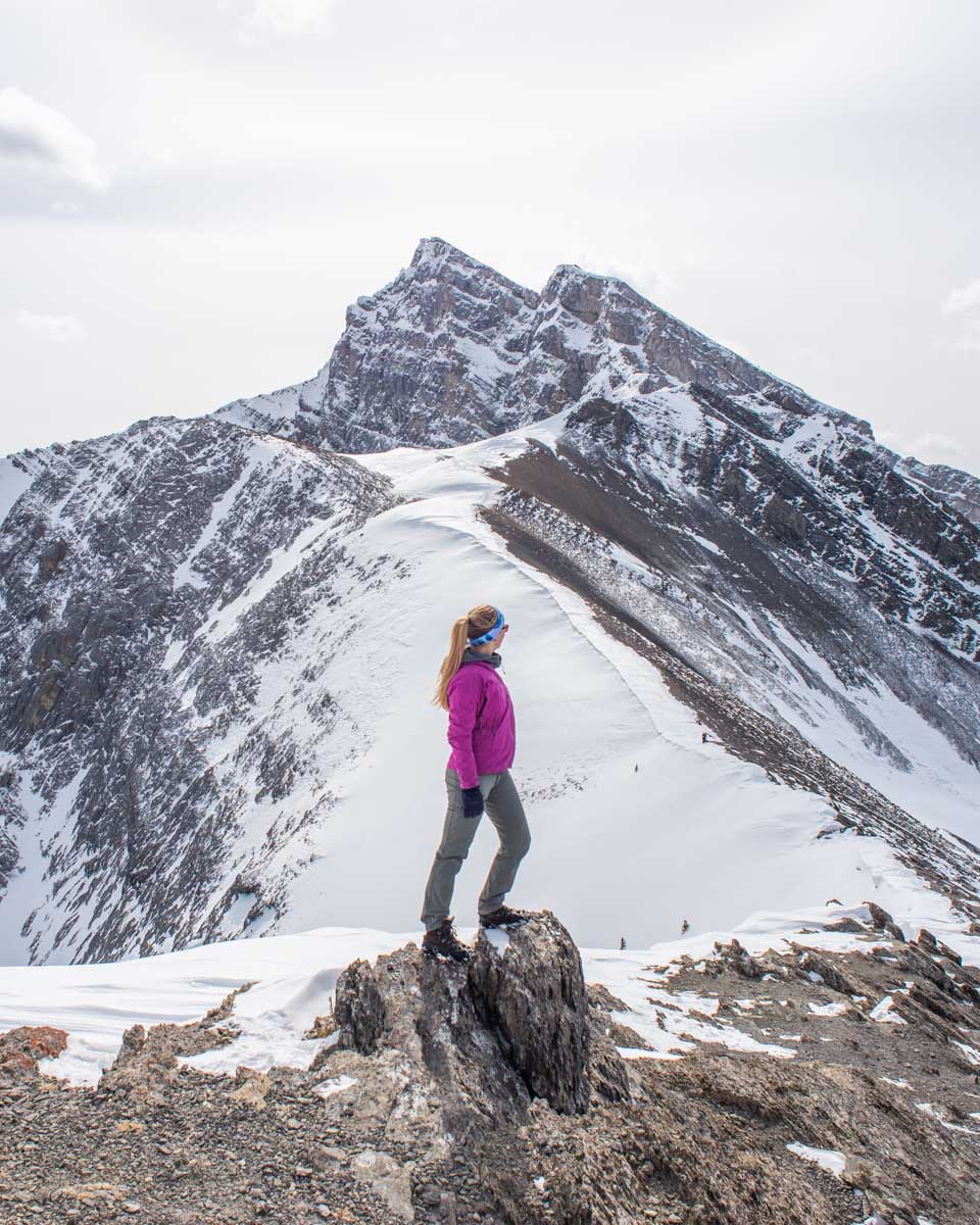 Bailey at the top of Ha Ling Peak in winter near Canmore, Alberta