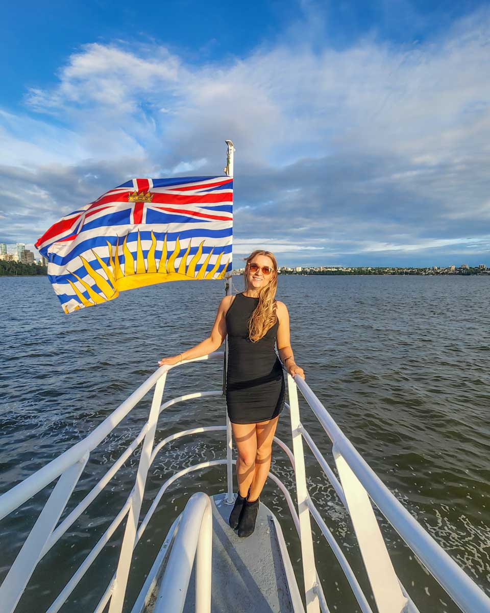 Bailey poses for a photo at the front of the boat on our sunset cruise in Vancouver