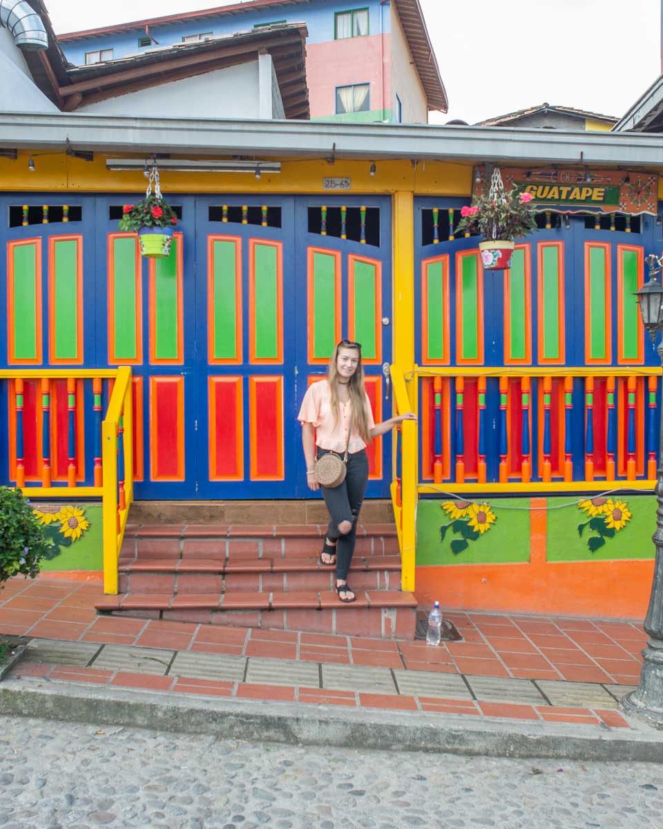 Bailey poses for a photo in front of a colorful building in Guatape
