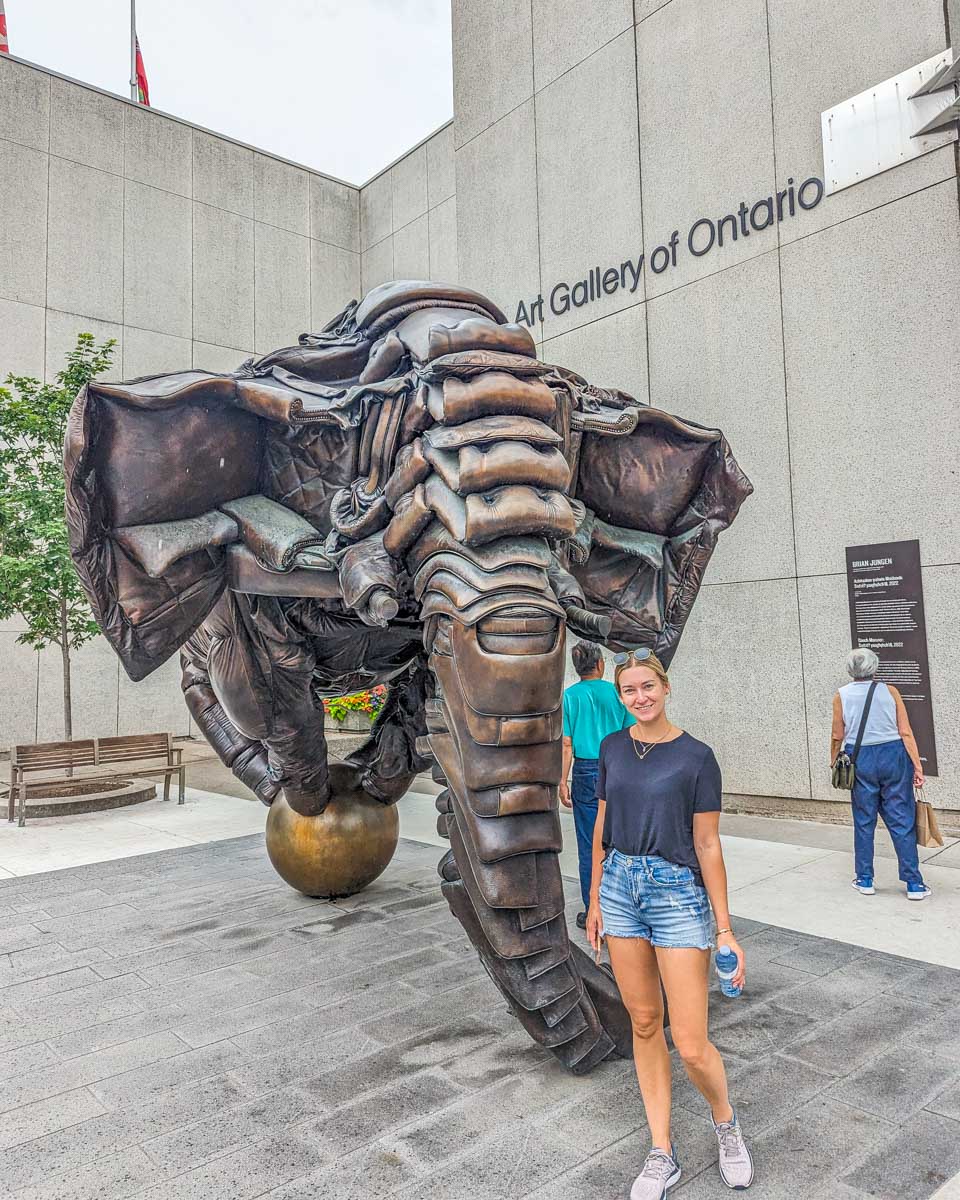 Bailey poses for a photo with a statue at the Art Gallery of Ontario, Toronto