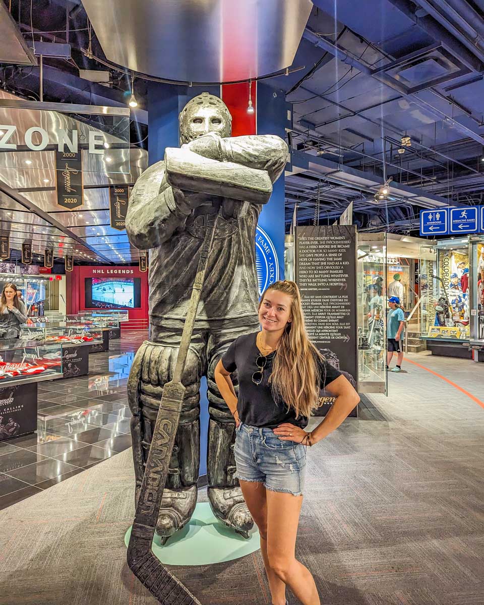 Bailey poses with a statue at the Hockey Hall of Fame in Toronto, Canada